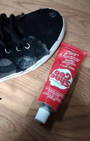 Shoe Goo Tube along with a Boot in the floor